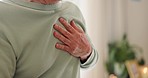 Senior, pain and hands of person on chest for cardiac arrest, heart attack and heartburn in home. Health, wellness and closeup of massage for relief, breathing problems and emergency in living room