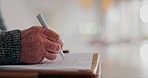 Elderly man, hands and writing on paperwork for retirement plan, legal agreement or application at home. Closeup of senior male person signing documents, form or finance for investment at house