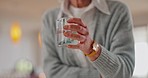 Parkinson, hand or senior woman drinking water for wellness or hydration to relax, arthritis and home. Glass, illness and closeup with thirsty elderly person, healthy or fresh h2o liquid for vitality