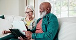 Old couple on sofa with paperwork, home budget and tablet with interracial marriage, discussion and planning. Bills, online banking and fintech, senior man and woman on couch with retirement savings.