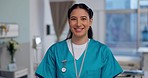 Nurse, face and woman in healthcare, happy with confidence at hospital with pride and help, caregiver with kindness. Medical professional, trust and smile at clinic, expert in portrait with health