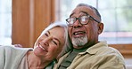 Talking, watching tv and senior couple in home, relax and happy together in retirement. Television, smile and elderly man and woman laugh at comedy movie, funny show or film for interracial people