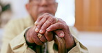 Walking stick, hands and elderly man with disability in home for support, healthcare or sick in retirement. Closeup, lonely senior and aid of wood cane for parkinson, arthritis or help rehabilitation