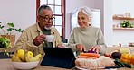 Cooking, speaking or old couple with tablet or food for a healthy vegan diet together in retirement at home. Online, interracial or senior woman in kitchen talking to an elderly man for dinner recipe