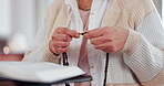 Hands, woman and bible with rosary for praying, spiritual faith and holy trust to worship God at home. Closeup, christianity and prayer beads for religion, gospel books and praise to Jesus Christ 