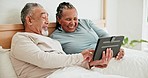 Smile, tablet and mature couple in bed, typing and talking together in the morning. Technology, happy man and interracial woman in bedroom for funny meme on internet, laugh and social media at home