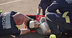 Hands, emergency oxygen and an emt team with a patient or victim on the street for accident treatment. Healthcare, medical or first aid with a paramedic group working to rescue a person from above