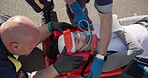 Hands, oxygen for first aid and a paramedic team with a patient or victim on the street for accident treatment. Healthcare, medical or emergency with an emt and colleague working to rescue a person