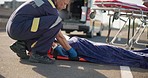 Road, accident and medic with person on stretcher for emergency care, safety and transport. Man, medical professional or serious for patient, oxygen mask or first aid to hospital, exam or surgery