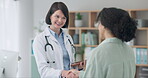 Happy, doctor and handshake of patient to welcome, greeting and meeting in hospital. Medical worker shaking hands with woman, consultation and conversation for healthcare, checkup tablet and wellness