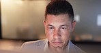 Thinking, night and young businessman in office doing research for a creative project with deadline. Serious, focus and professional male designer from Mexico working on computer in modern workplace.