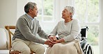 Wheelchair, senior couple and smile in conversation in a retirement home with support and holding hands. Trust, love and man with a disability with speaking and discussion with empathy in marriage