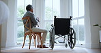 Sad, senior man and death of wife in home with wheelchair, window and memory of sitting together in living room. Elderly, couple and person mourning, loss and remember partner with grief on chair