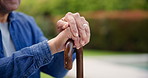 Cane, park and hands of senior person in nature to relax for outdoor peace or calm with walking stick. Environment, backyard and elderly with support, care or retirement with wellness or assistance