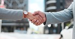 Business people, meeting and shaking hands in city for agreement, b2b promotion or success of deal. Closeup, team handshake and introduction of partnership, support integration or negotiation outdoor