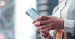 Business woman, hands and smartphone in city to search for contact, social network or check notification. Closeup, employee and scroll on mobile for digital app, online connection or typing in street