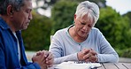 Old people in park, praying with Bible and worship, trust and faith in God with Christian and holy book. Couple outdoor with scripture, prayer and respect, guide and help with religion and wellness