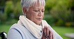 Outdoor, praying and senior woman with a rosary, faith and guidance with religion, peace and calm. Pensioner, elderly person or old lady with beads, Christian or Catholic with hope, park or spiritual