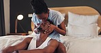 Bed, love and African couple kiss in bedroom together with care in relationship and with happiness in the morning. Care, bonding and happy man with woman for romance to relax in room on vacation