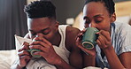 Love, coffee and relax with a black couple in the bedroom of their home together to wake up in the morning. Smile, drink or caffeine with a happy man and woman in bed for bonding in their apartment