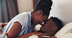 Bed, faces and African couple in bedroom together with love in relationship and with happiness in the morning. Care, bonding and happy man with woman for romance to relax in room on vacation