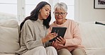 Tablet, conversation and woman with senior mother on a sofa networking on social media together. Digital technology, relax and female person scroll on internet or mobile app with elderly mom at home.