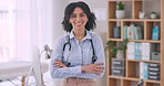 Face, doctor and woman with arms crossed, office and career with stethoscope, consultant and healthcare. Portrait, employee and medical professional with happiness, hospital or medicare with ambition