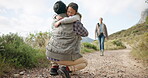 Running, hiking and daughter hugging her father in the mountains while outdoor for family adventure. Love, travel and freedom with a parent and girl child embracing during a forest hike together