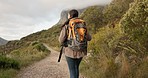 Woman, back and walk for hiking, mountains or thinking with location, nature or freedom on vacation. Girl, hill and bush for trekking, backpack or exercise with direction, travel or outdoor adventure