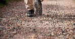 Hiking, legs or person walking on path for fitness for adventure, trekking or freedom. Closeup of shoes, mountain trail or hiker in outdoor nature for wellness, travel or exercise on holiday vacation