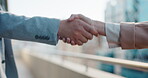 Business, people and handshake outdoor with welcome, collaboration or meeting for deal or partnership in city. Man, woman or employees with shaking hands closeup for teamwork, partnership or hello