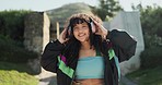 Dance, headphones and a woman walking in a park during summer for freedom or movement in rhythm. Portrait, energy or fashion with a happy young person moving to music in a garden for stress relief