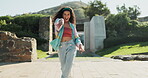 Dance, energy and a woman walking outdoor in a park during summer for freedom or movement in rhythm. Portrait, smile or fashion with a happy young person moving to music in a garden for stress relief