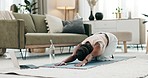 Yoga, spine or black woman stretching in home or house studio for wellness, peace or balance. Pilates, flexible or zen African person in cat pose for energy training, breath or holistic exercise 