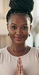 Yoga, face and zen with a black woman on the floor of a living room in her home for health or wellness. Portrait, exercise and meditation with a happy young person in her apartment for mindfulness