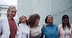 Team, hug and business women in city, walk or solidarity outdoor, funny laugh or conversation. Happy group, employees and people in urban town, creative designers embrace for support or empowerment