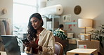 Phone, laptop and a woman designer in her workshop for product shipping an online order or delivery. Technology, small business and supply chain logistics with a young employee in a startup studio 