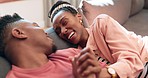 Holding hands, relax and happy black couple laughing at funny conversation, relationship humour or marriage bond. Eye contact, love connection or African man, woman or home people joke on lounge sofa