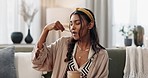 Woman, eat and ice cream for enjoy at home to relax with delicious snack, dessert and sweet with spoon. Indian person, taste and hungry for food on sofa in living room for break, relaxation and peace