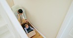 Moving, dad and kid with box, playing and happy with real estate, love and adventure in home from above. Property, father and girl with fun, smile and energy in hallway of new house with freedom.