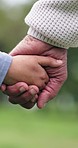Holding hands, grandparent and child in park with trust, love and bonding on outdoor walk in nature. Family care, generations and old person with kid in garden together, relax and respect in support 