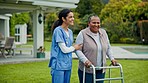 Elderly care, old woman with walker and nurse in garden with support, help or trust at nursing home. Retirement healthcare, senior person and happy caregiver walk or talk on grass together with smile