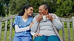 Happy woman, nurse and patient with coffee on park bench or swing in relax for healthcare in nature. Female person or medical caregiver sitting outdoor with senior, tea or beverage in care or support