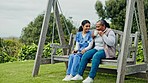 Happy woman, nurse and patient with coffee on swing or park bench in relax for healthcare in nature. Female person or medical caregiver sitting outdoor with senior, tea or beverage in care or support