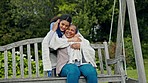 Happy woman, doctor and patient hug on park bench in elderly care, healthcare or support in nature. Female person smile helping in outdoor nursing with blanket, love or trust for retirement in garden