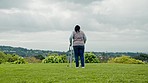 Black woman, elderly with walker and retirement, outdoor in garden with fresh air and relax in nature. Environment, person with disability and rehabilitation, senior care and back view in countryside