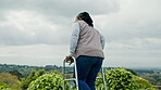 Black woman, senior with walker and retirement, walking outdoor in garden with fresh air and nature. Environment, person with disability and rehabilitation, elderly care and back view in countryside