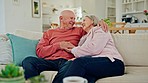 Senior couple, hug and talk on sofa in home living room for memory, thinking and smile for romance. Elderly man, old man and embrace for with idea for care, bonding and chat on lounge couch in house