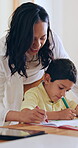 Family, book or coloring with a mother and son in their home together for education, learning or development. Art, creative or drawing with a woman and boy child in their apartment for bonding