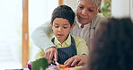 Grandmother, boy or cooking food in kitchen with learning, help and child development and instructions. Family, senior woman or kid with how to, teaching and cutting vegetables with talking or smile 